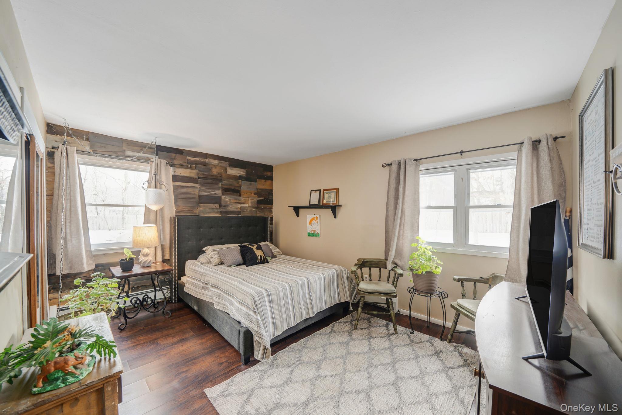 6 Howe Court Coram, NY 11727 - Photo 12 of 17 a bedroom with a bed table chair and a window