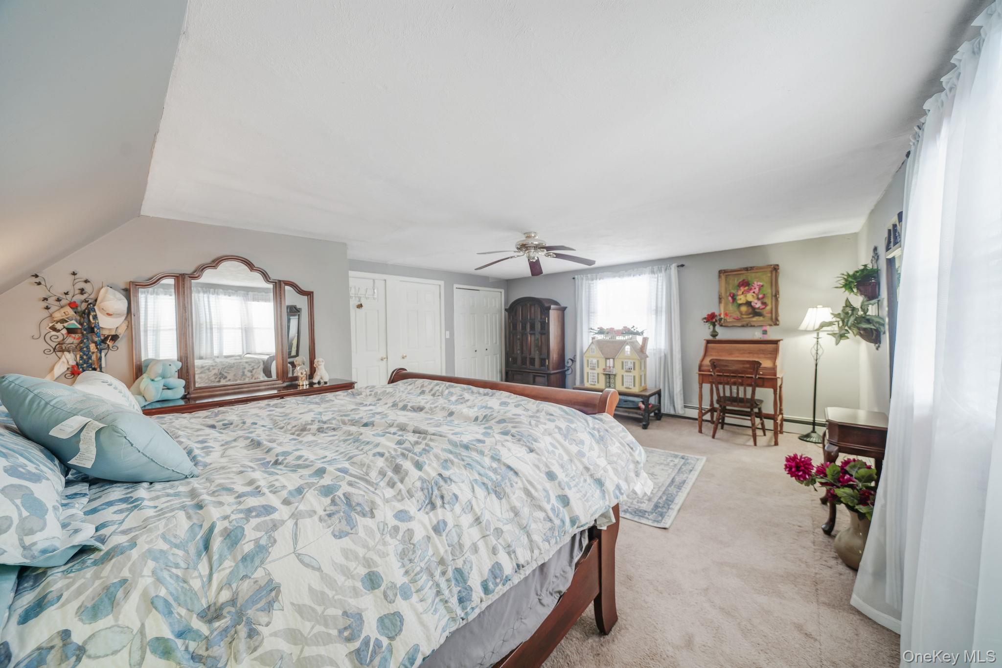6 Howe Court Coram, NY 11727 - Photo 15 of 17 a bedroom with a bed large mirror and furniture
