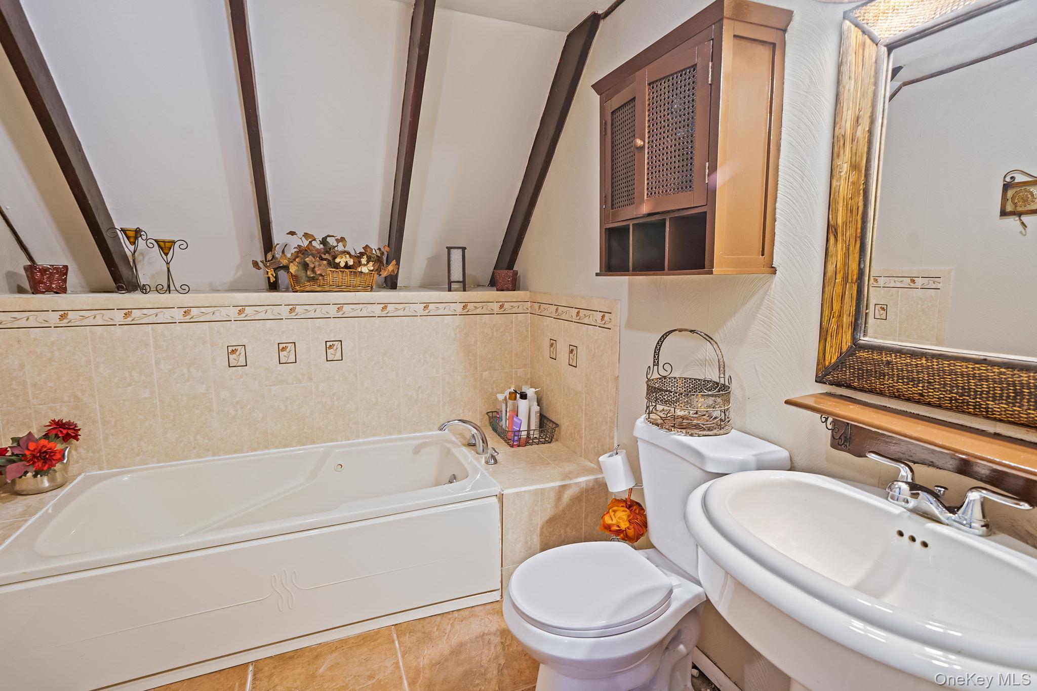 6 Howe Court Coram, NY 11727 - Photo 16 of 17 a bathroom with a sink a toilet and a bathtub