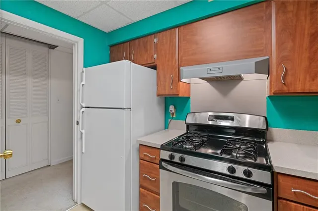 a kitchen with a stove and a refrigerator