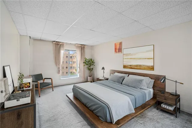 a bedroom with a bed wooden floor and a window