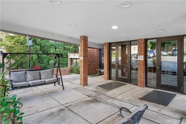a bedroom with furniture and large windows