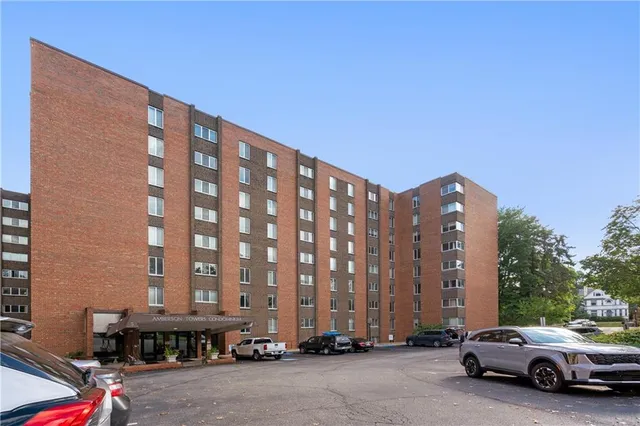 a view of building with car parked