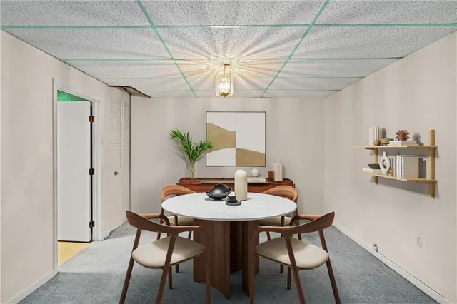 a view of a dining room with furniture and chandelier