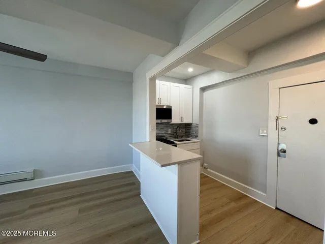 a kitchen with a refrigerator and a stove top oven