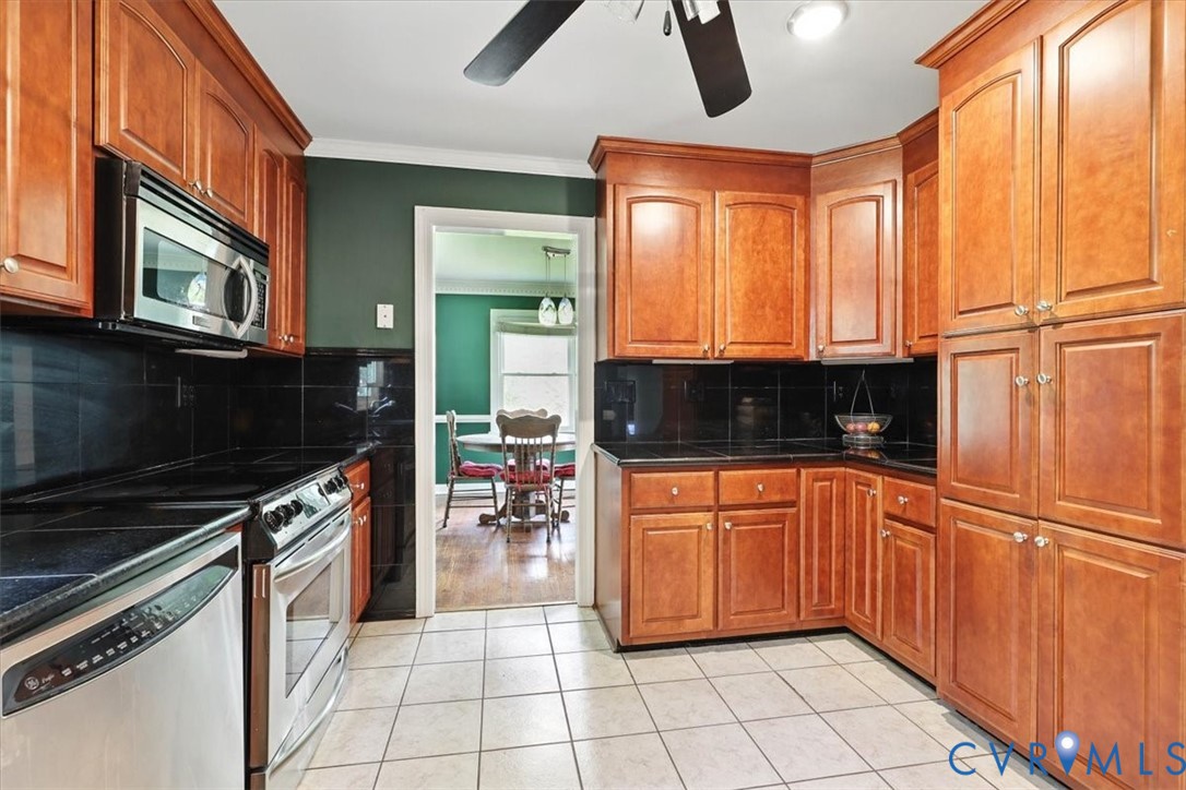 11310 Celtic Road Chesterfield, VA 23838 - Photo 11 of 21 a kitchen with stainless steel appliances granite countertop a stove a sink and a microwave