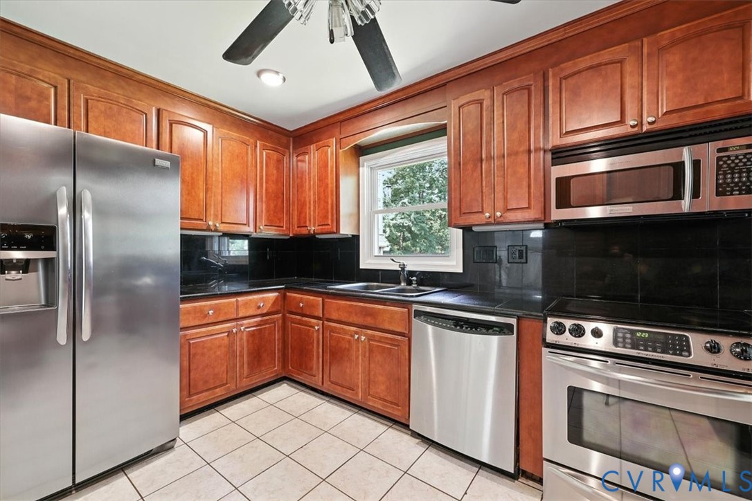 11310 Celtic Road Chesterfield, VA 23838 - Photo 12 of 21 a kitchen with stainless steel appliances granite countertop a stove a sink and a microwave