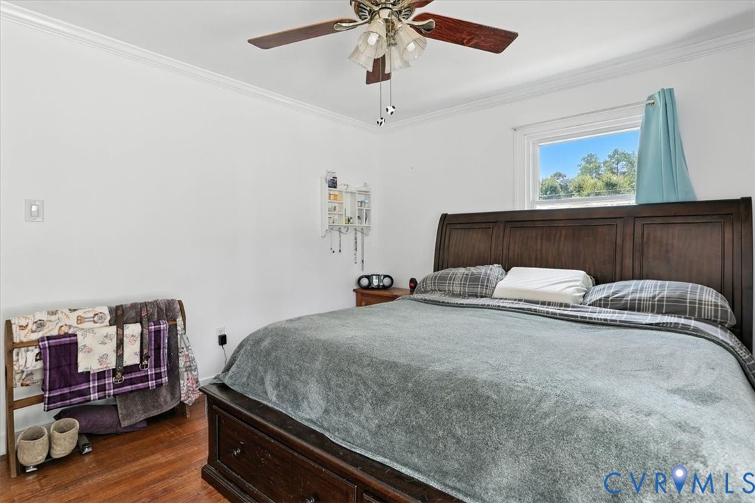 11310 Celtic Road Chesterfield, VA 23838 - Photo 14 of 21 a bedroom with a bed and wooden floor
