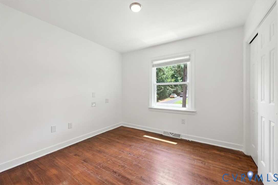 11310 Celtic Road Chesterfield, VA 23838 - Photo 18 of 21 an empty room with wooden floor and windows