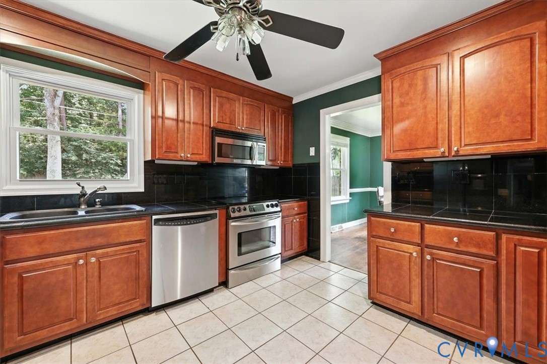 11310 Celtic Road Chesterfield, VA 23838 - Photo 10 of 21 a kitchen with stainless steel appliances granite countertop a stove sink and microwave