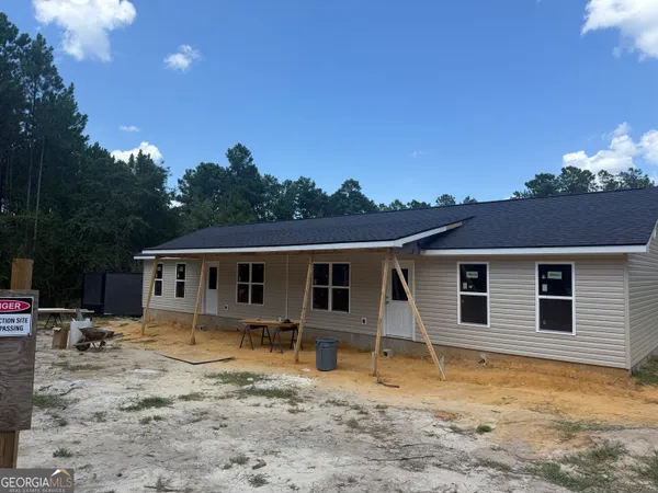 a view of a house with a backyard