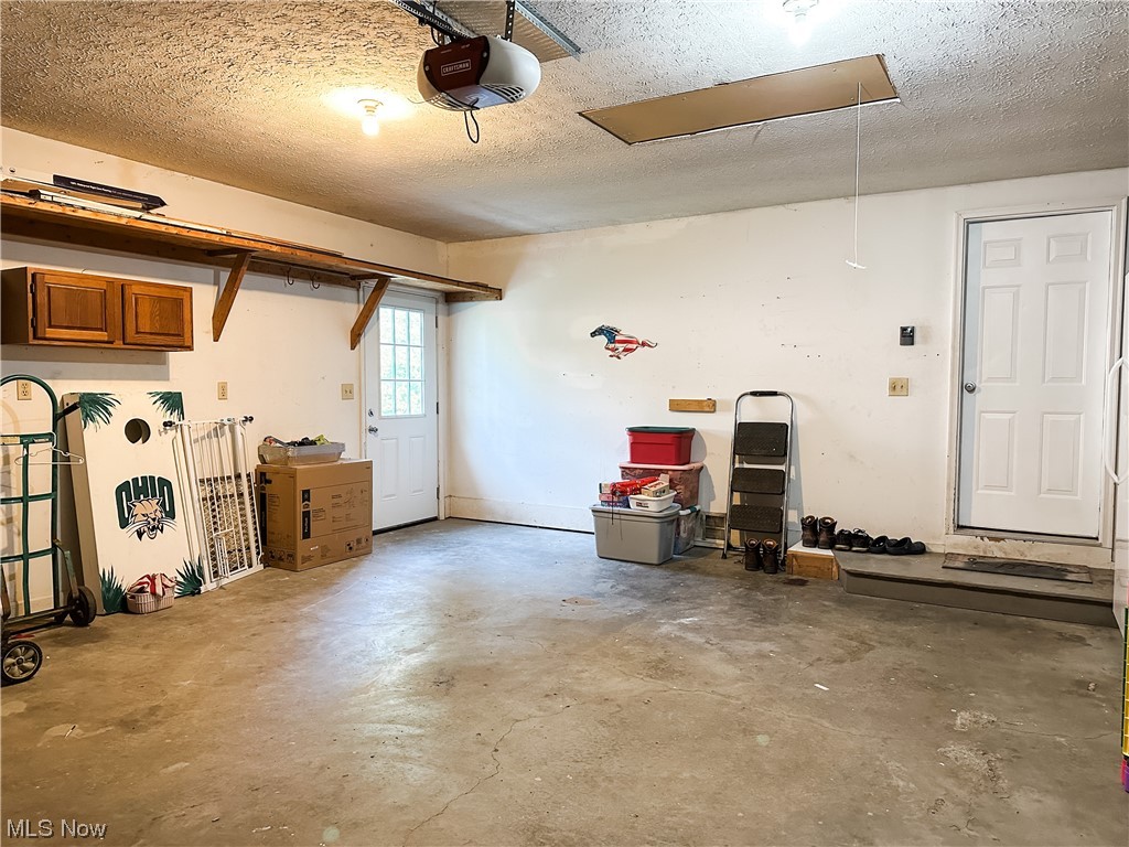 4354 School House Road Little Hocking, OH 45742 - Photo 22 of 35 2 car garage with man door of the left and entrance into home on the right ...
