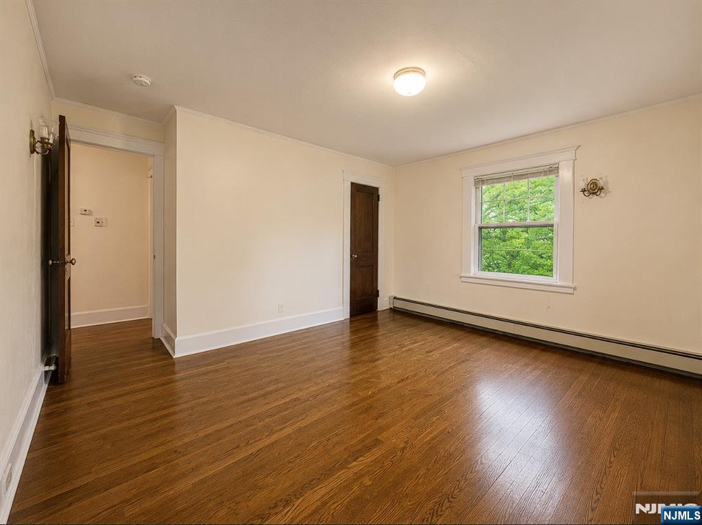84 Valley View Avenue Ridgewood, NJ 07450 - Photo 11 of 20 an empty room with wooden floor and windows