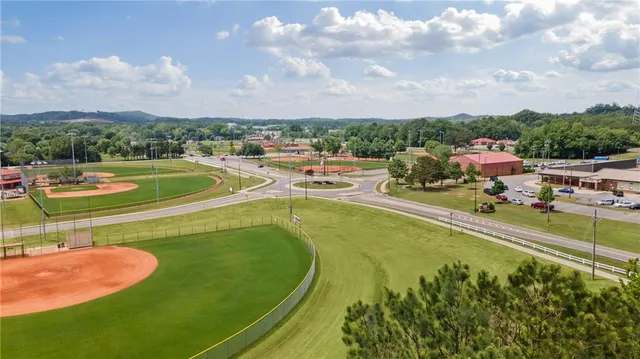 a view of a swimming pool is in the backyard of a house