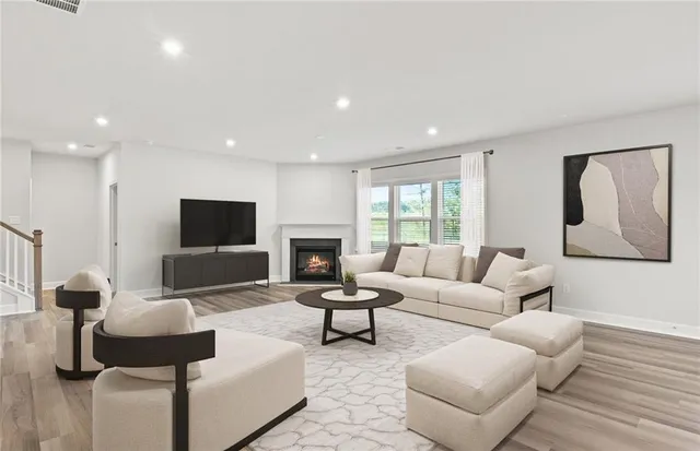 a living room with furniture and a flat screen tv