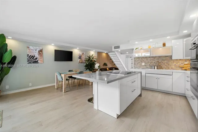a kitchen with a sink cabinets and window