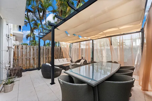 a dining room with furniture and a floor to ceiling window