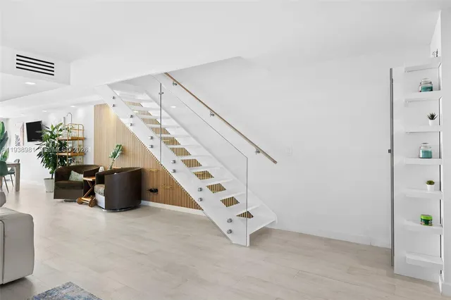 a view of a hallway with a white refrigerator