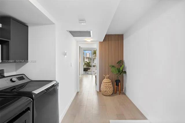 a bedroom with a large bed and a painting on the wall