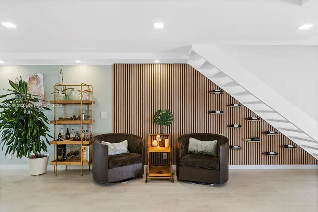 a living room with furniture and a potted plant