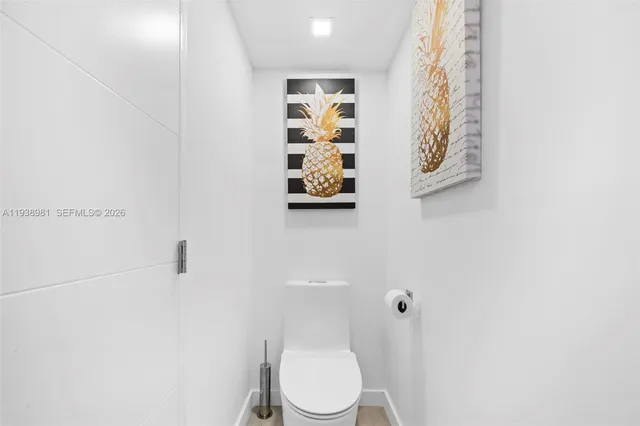 a white toilet sitting next to a bathroom sink