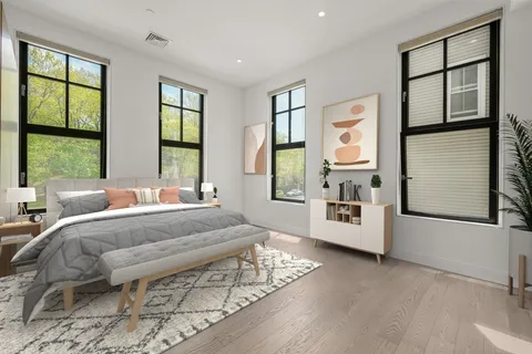 a large bedroom with a large bed and a large window