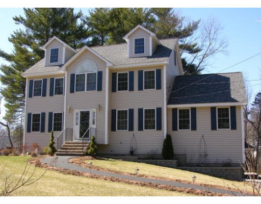 6 Arcadia Road Billerica, MA 01821 - Photo 1 of 10 a view of a white house with large windows next to a road