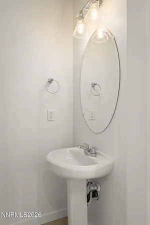 a bathroom with a sink a mirror and vanity