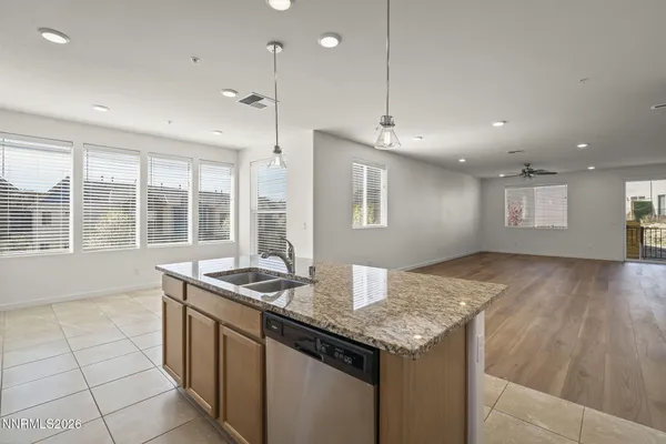 a kitchen with granite countertop sink and stove