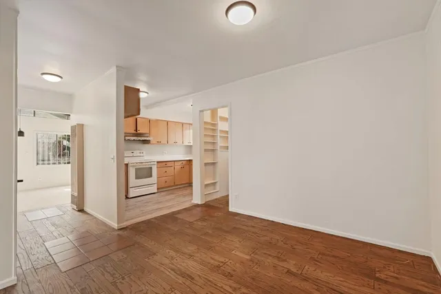 a view of a kitchen with wooden floor and electronic appliances