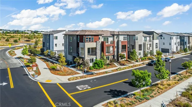 an aerial view of residential houses with city view