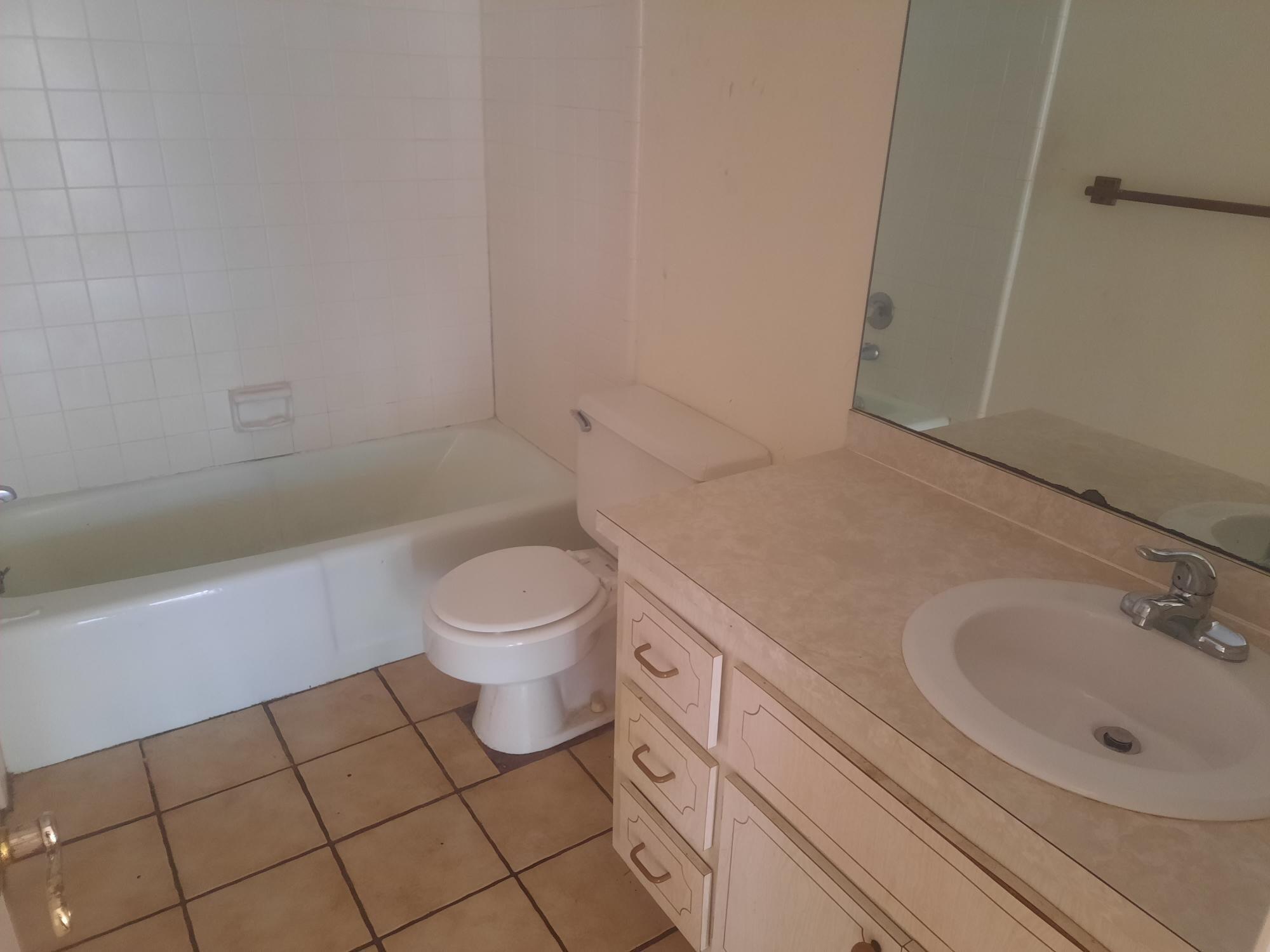 2050 Oleander Boulevard, Unit 7301 Fort Pierce, FL 34950 - Photo 12 of 12 a bathroom with a sink a toilet and a bathtub