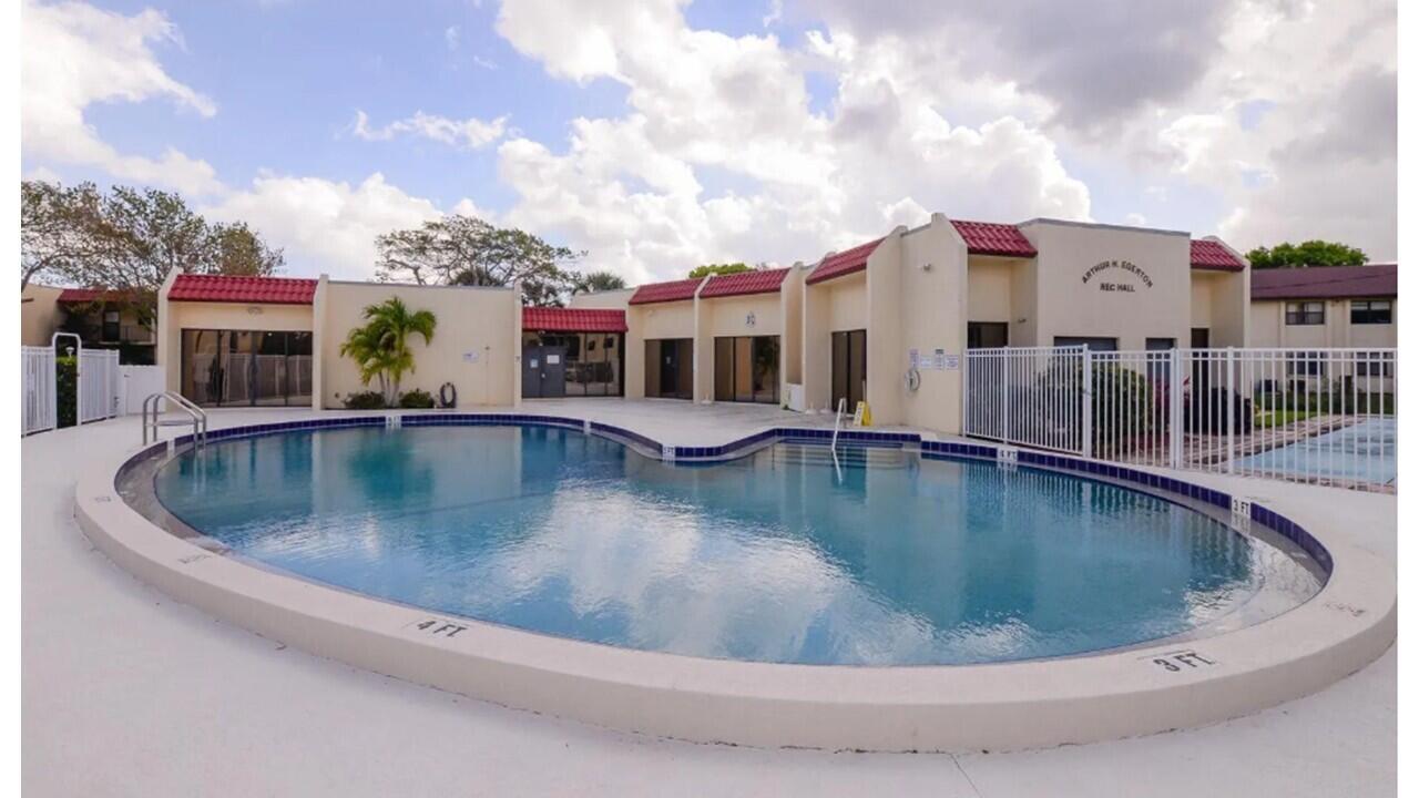 2050 Oleander Boulevard, Unit 7301 Fort Pierce, FL 34950 - Photo 6 of 12 a view of a house with swimming pool and sitting area