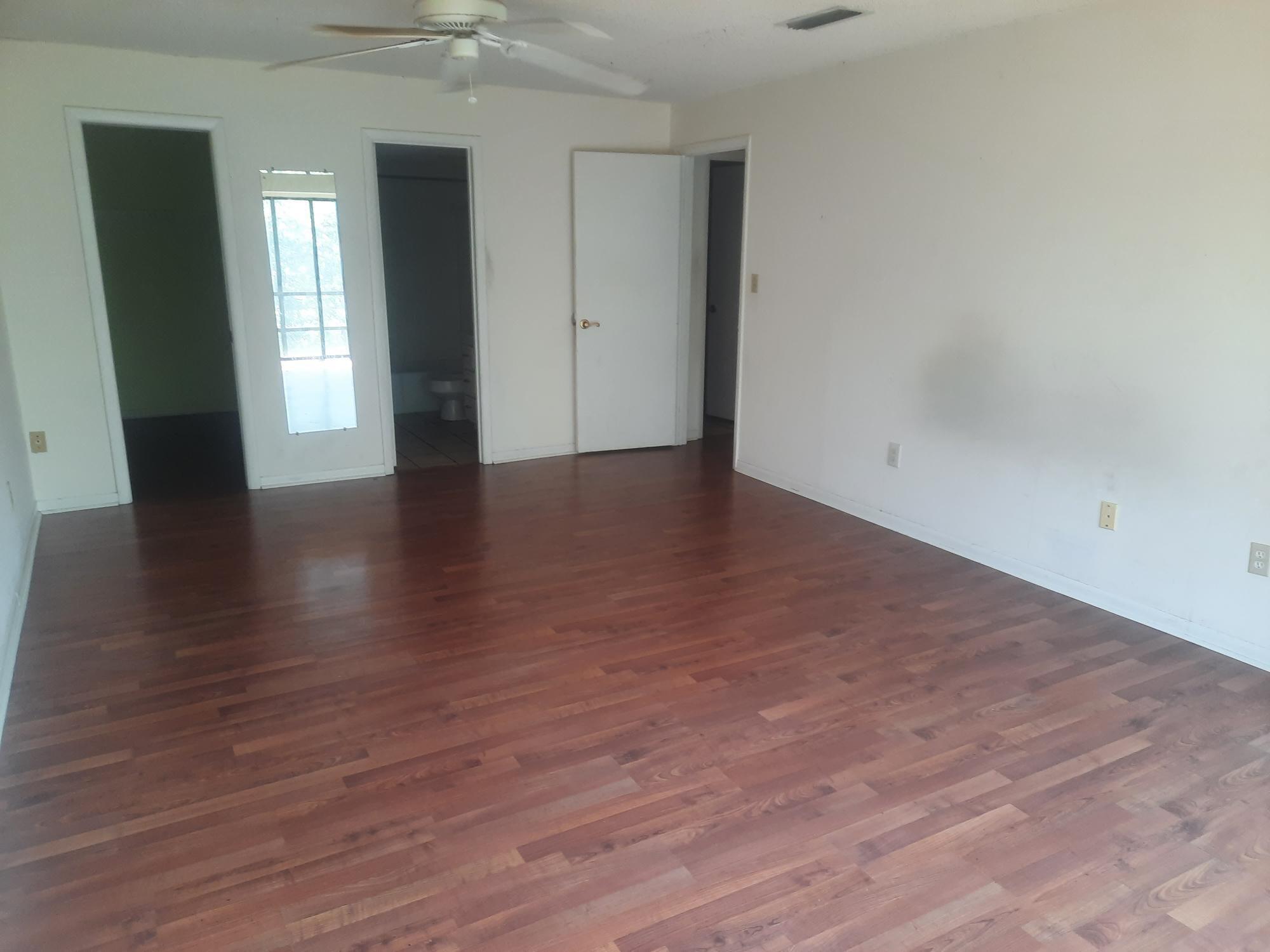 2050 Oleander Boulevard, Unit 7301 Fort Pierce, FL 34950 - Photo 7 of 12 a view of an empty room with wooden floor and a window