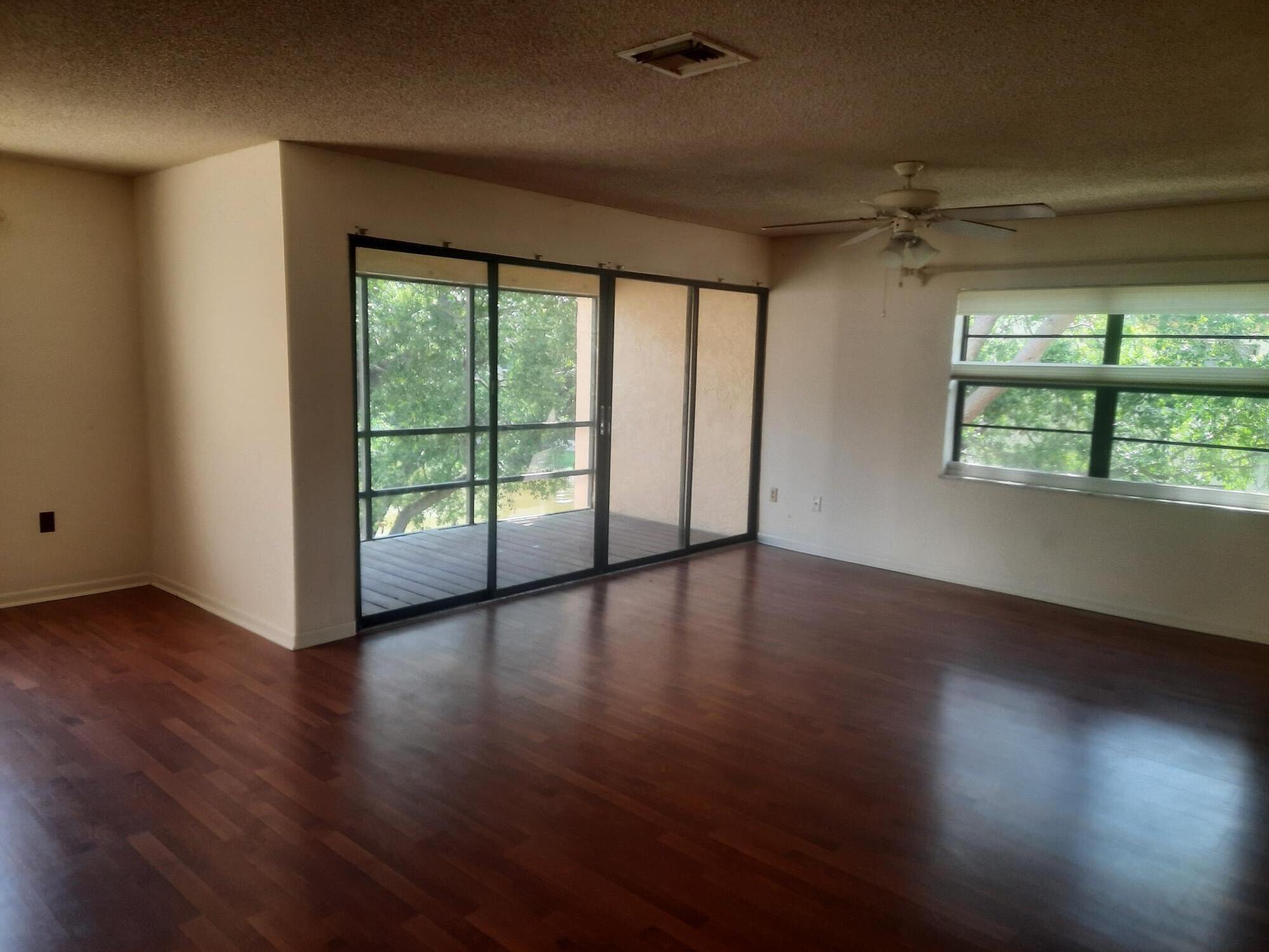 2050 Oleander Boulevard, Unit 7301 Fort Pierce, FL 34950 - Photo 9 of 12 an empty room with wooden floor and windows