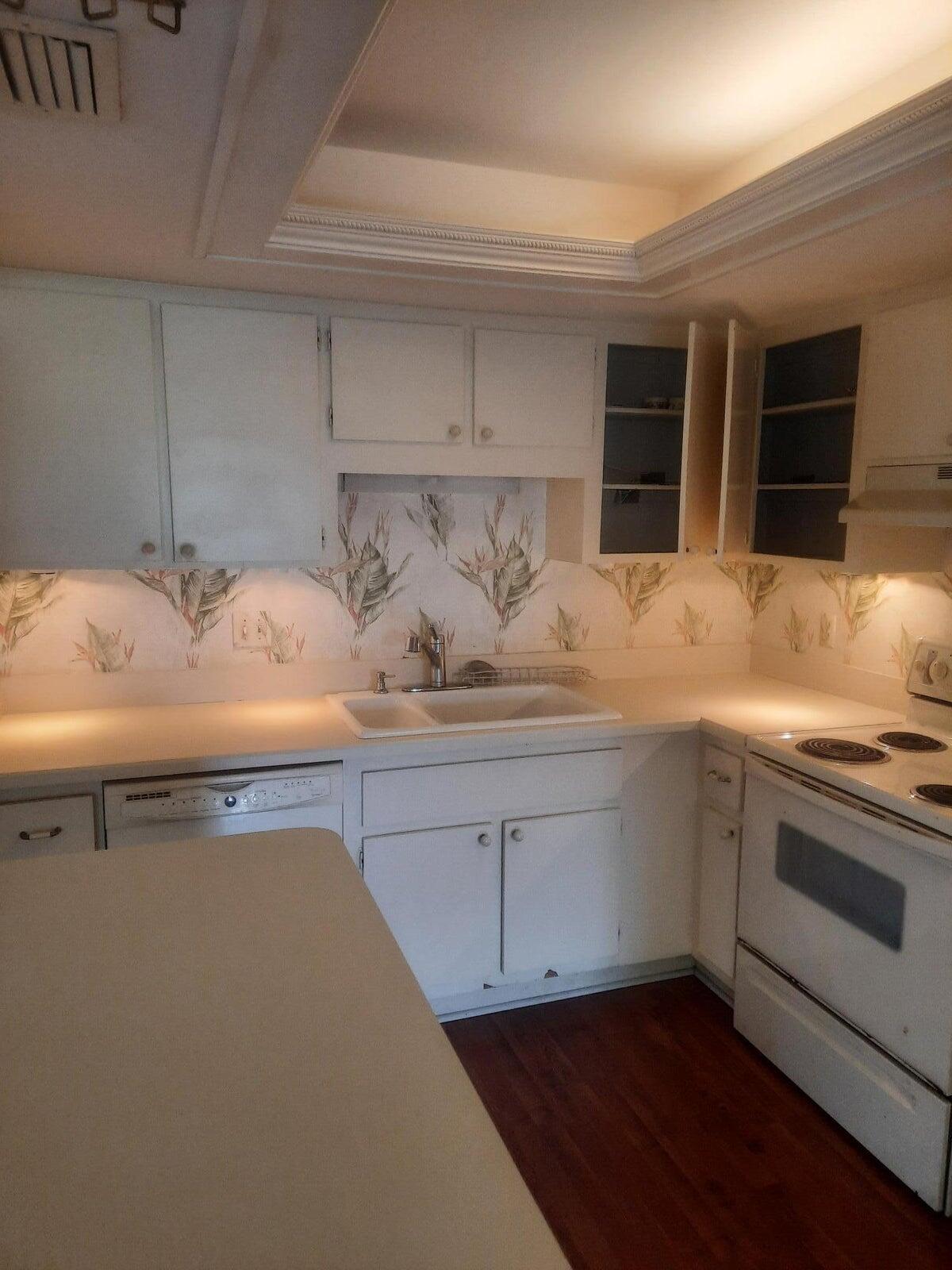 2050 Oleander Boulevard, Unit 7301 Fort Pierce, FL 34950 - Photo 10 of 12 a kitchen with a sink and cabinets