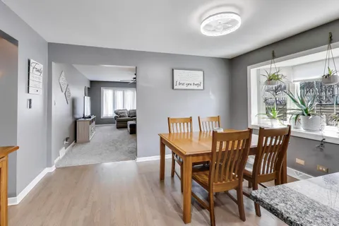 a view of a dining room with furniture and a kitchen