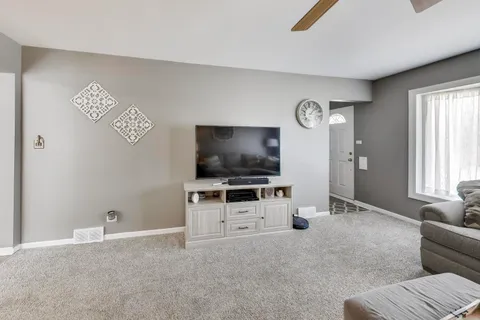 a bedroom with a bed and a ceiling fan