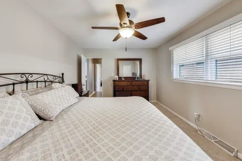 a bedroom with a bed and a chandelier