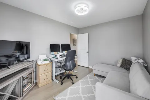 a living room with furniture fireplace and a window