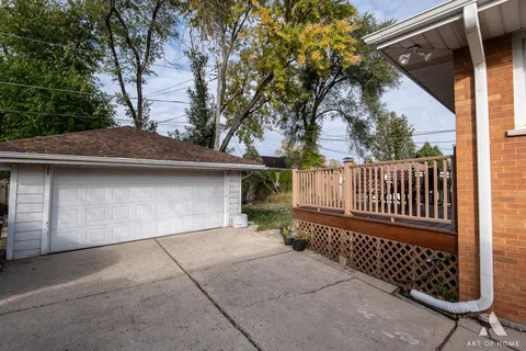a view of balcony with wooden floor outdoor seating and yard in back