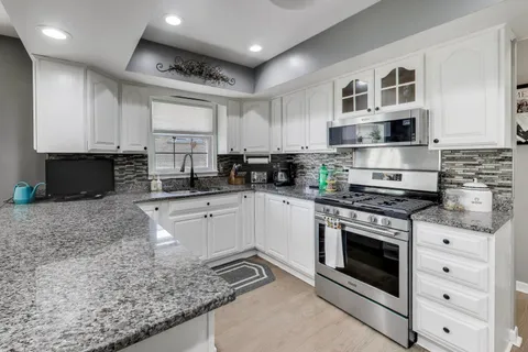 a white refrigerator freezer sitting in a kitchen