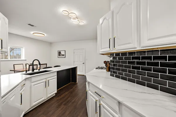 a kitchen with appliances cabinets and a sink