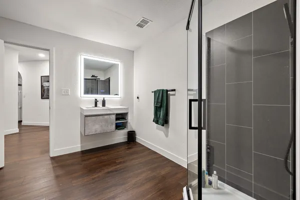 a bathroom with a shower and a sink