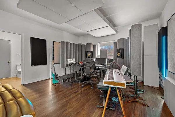 a view of a room with furniture and wooden floor