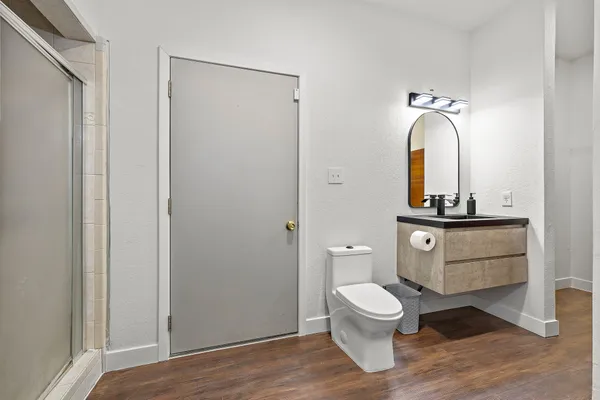 a bathroom with a toilet a sink and mirror