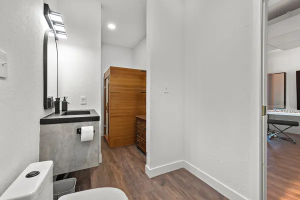 a bathroom with a sink a toilet and shower