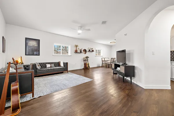 a living room with furniture and wooden floor