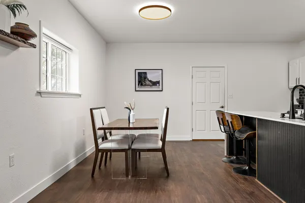 a view of a dining room with furniture and wooden floor