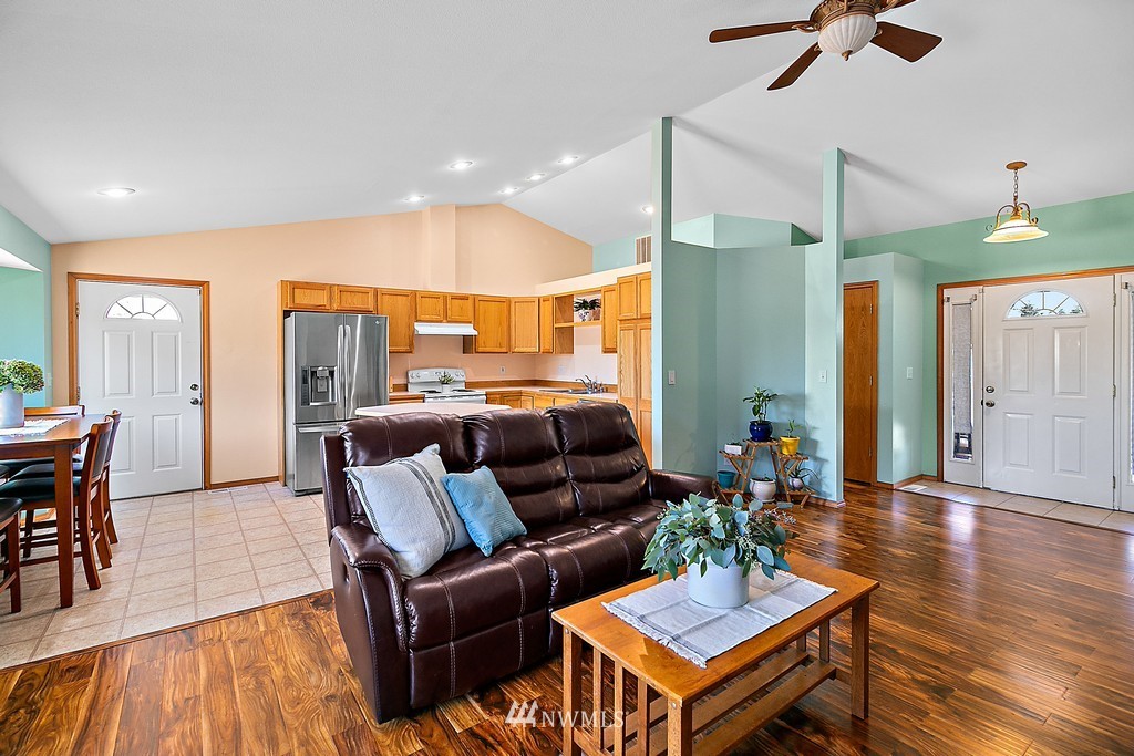 5121 183rd Lane Southwest Rochester, WA 98579 - Photo 13 of 31 a living room with furniture a ceiling fan and a rug
